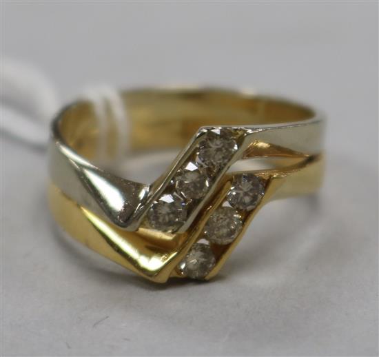 A two colour 18ct gold and six stone diamond ring, size O.
